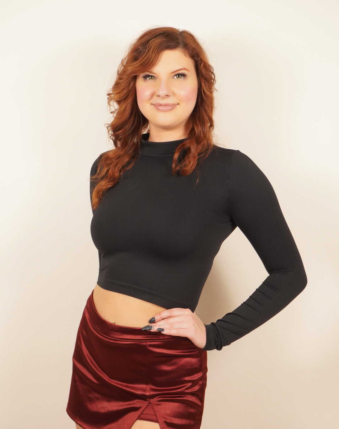 Close-up of high neck detail on black long-sleeve crop top