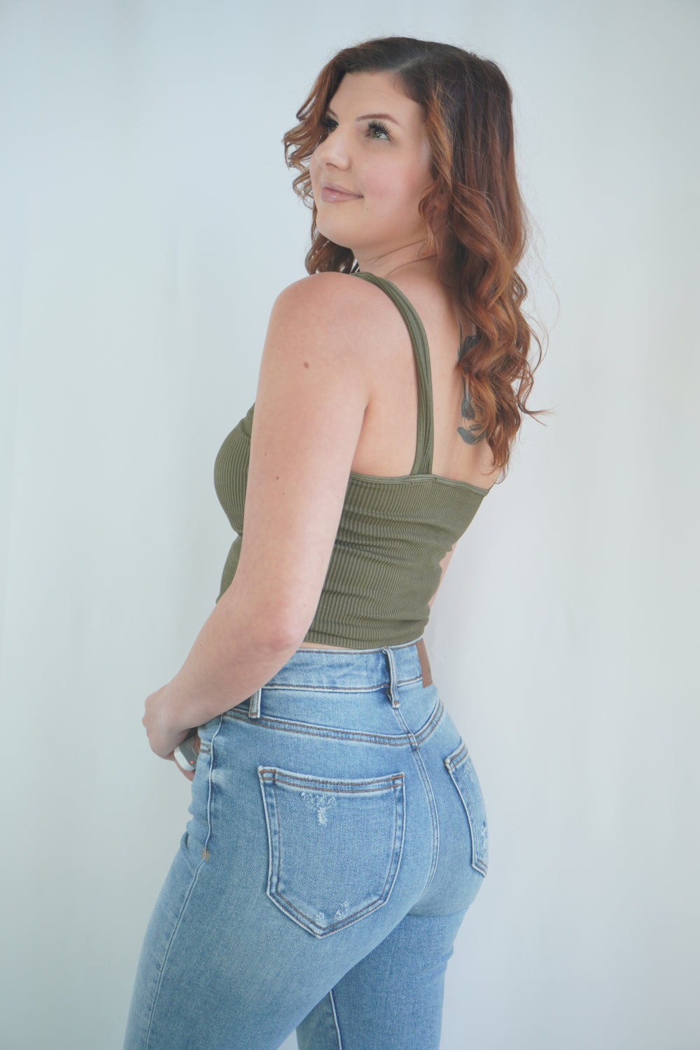 Side view of fitted ribbed crop tank in moss green